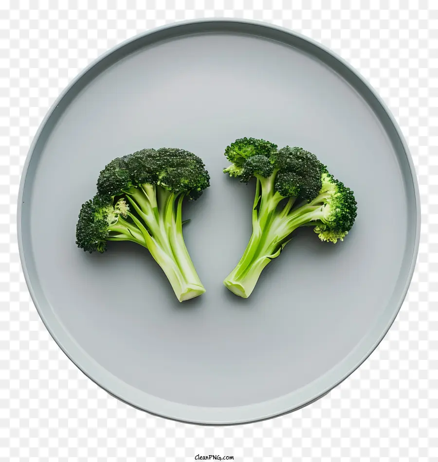 Brokkoli Brokkoli Teller Nahaufnahmegrünes Gemüse - Nahaufnahme von drei Brokkoli-Köpfen auf der Platte