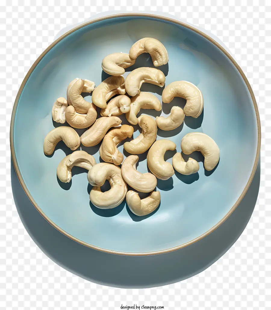 Cashew Cashews Bowl geschnitten roh - Schüssel mit geschnittenen rohen Cashewnüssen, blaue glänzende Oberfläche
